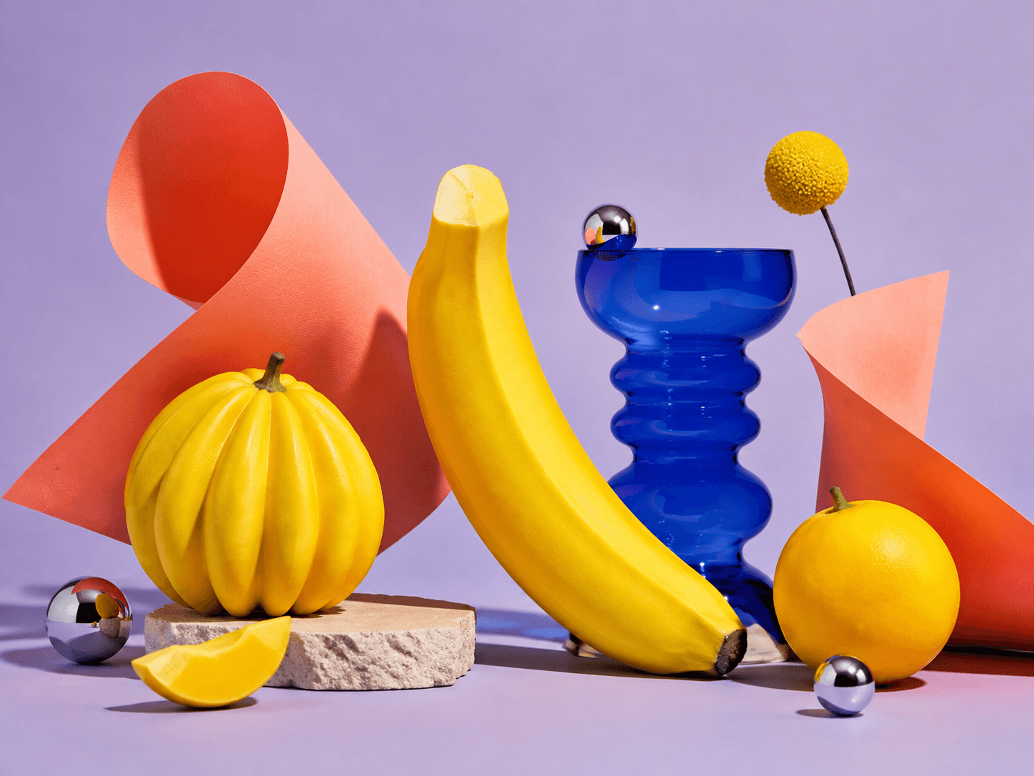 Colorful editorial still life with yellow fruit and cobalt glass